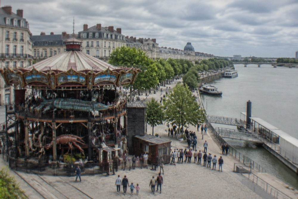 Families boarding a three-storey carousel of mechanical sea creatures beside a dock basin