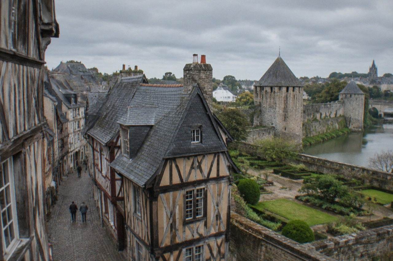 Timber-framed houses with dark wooden beams lining a narrow street in a historic Breton town