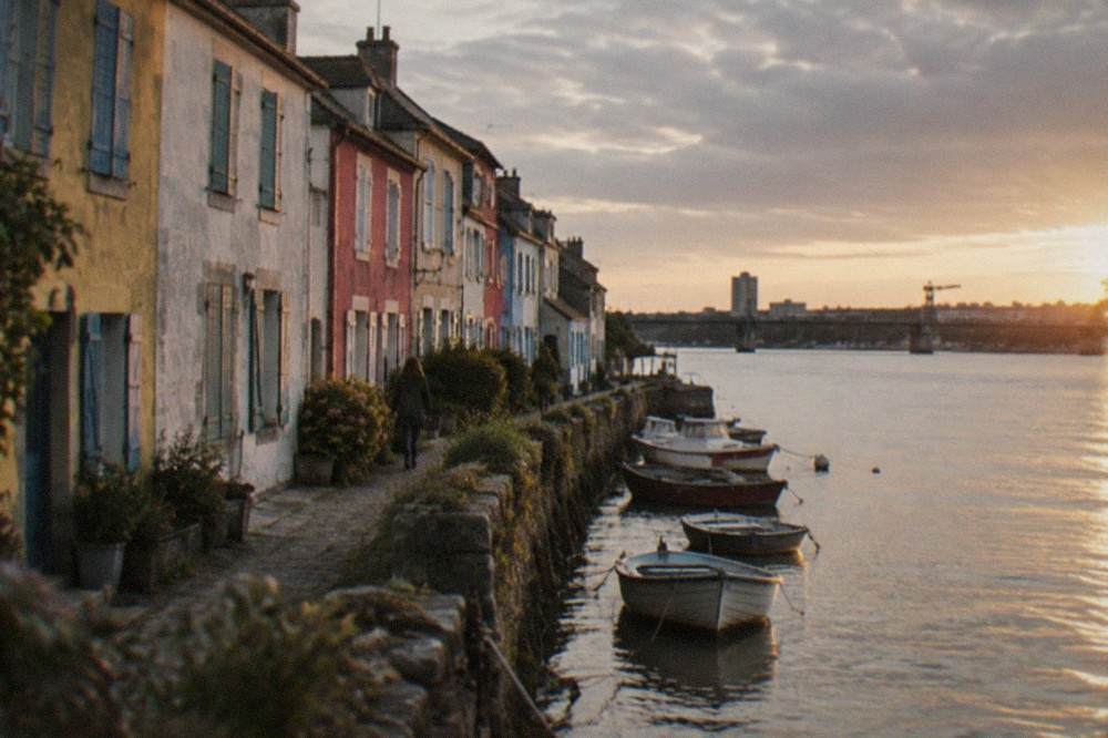 Colour-washed fishermen's houses and small boats at the water's edge in Trentemoult at golden hour