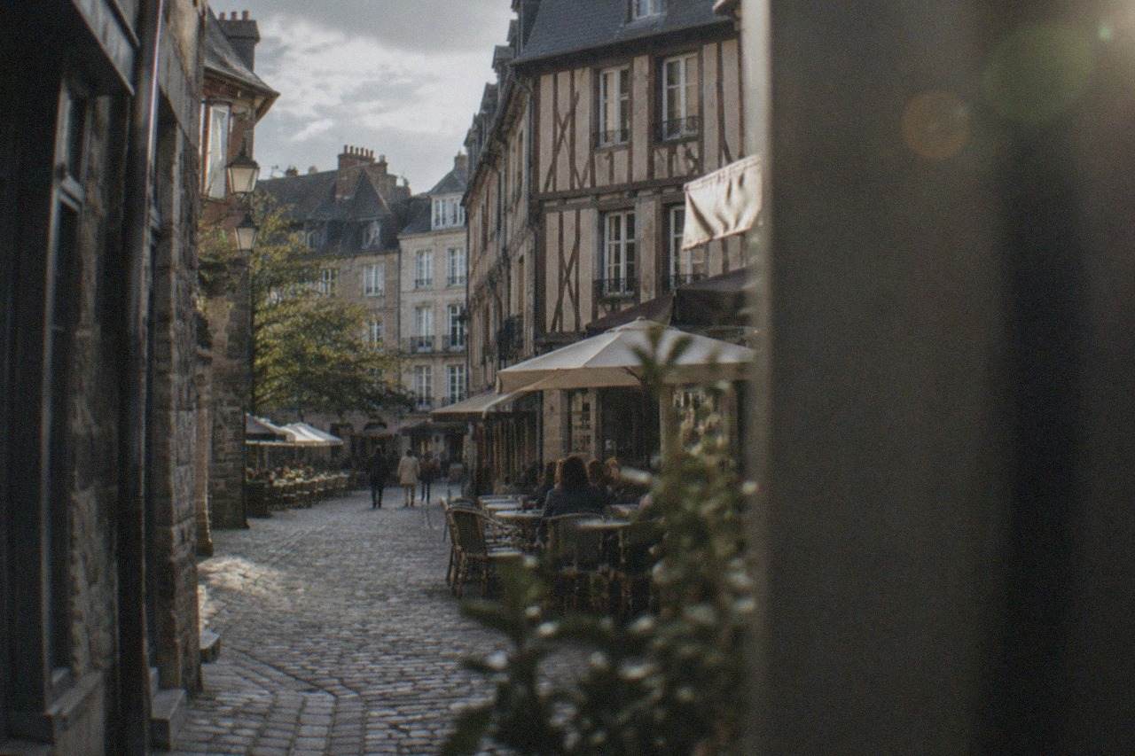 Narrow medieval street with half-timbered houses and cafés in the old town of Nantes