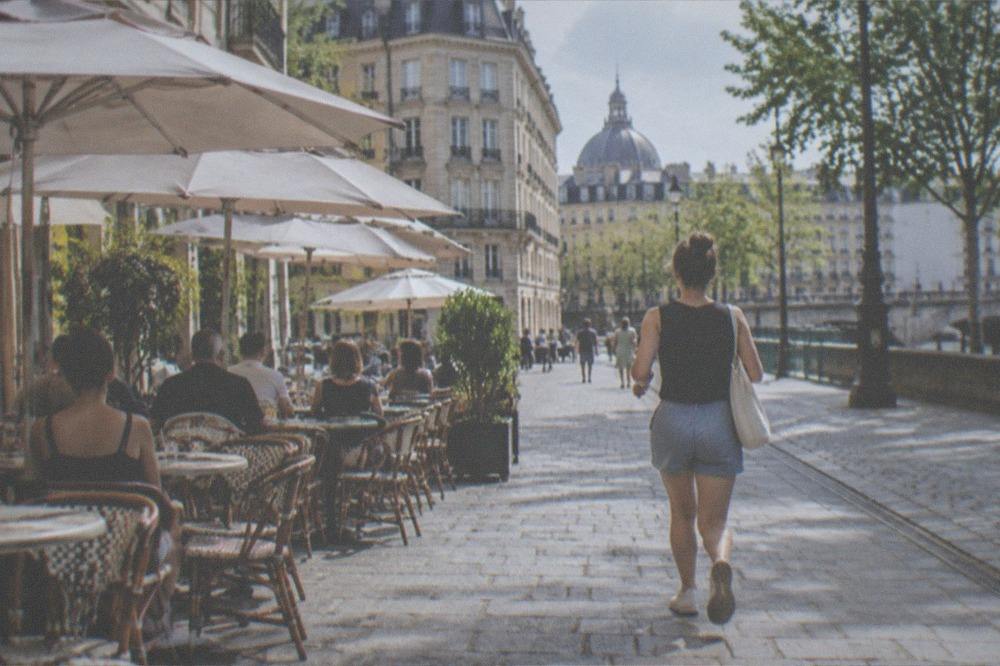 Sunlit café terrace on a stone street in the old town of Nantes in summer