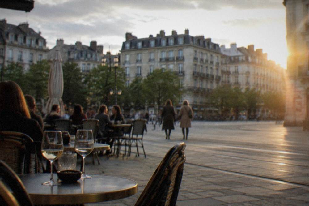 Evening light on the old marketplace square with people at outdoor tables in Nantes
