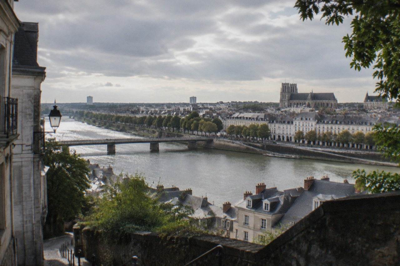 A view across the Loire from a hillside street in western Nantes, with the river and city rooftops below