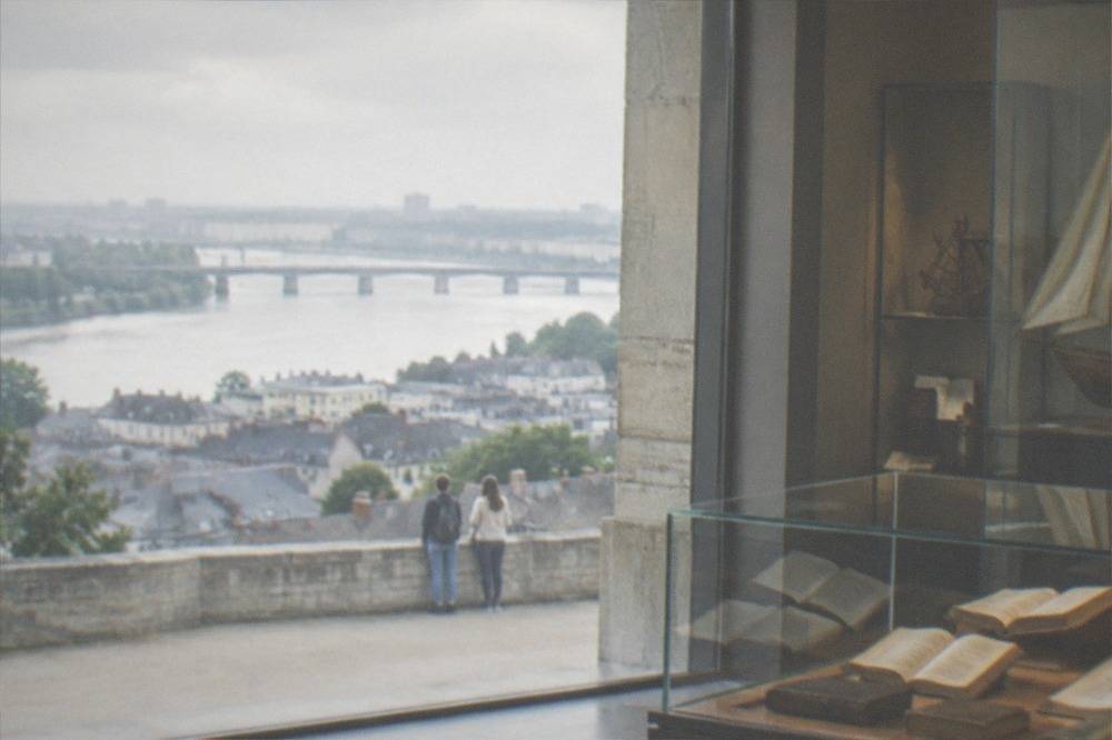 The interior of a small museum with display cases of books, manuscripts and nautical objects