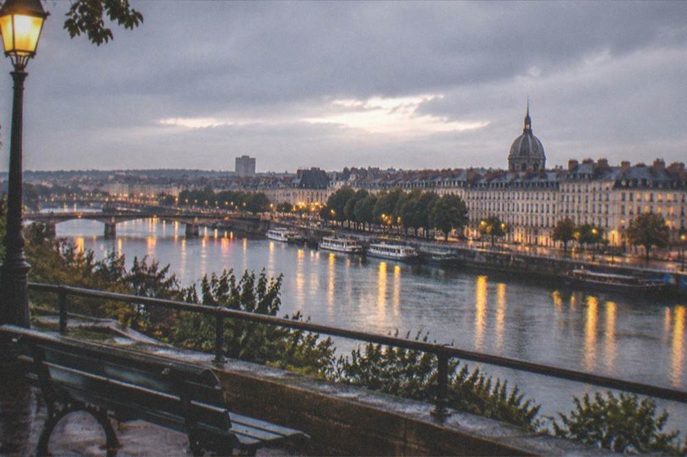 An evening view over the Loire from a hilltop terrace in Nantes, with the river reflecting city lights