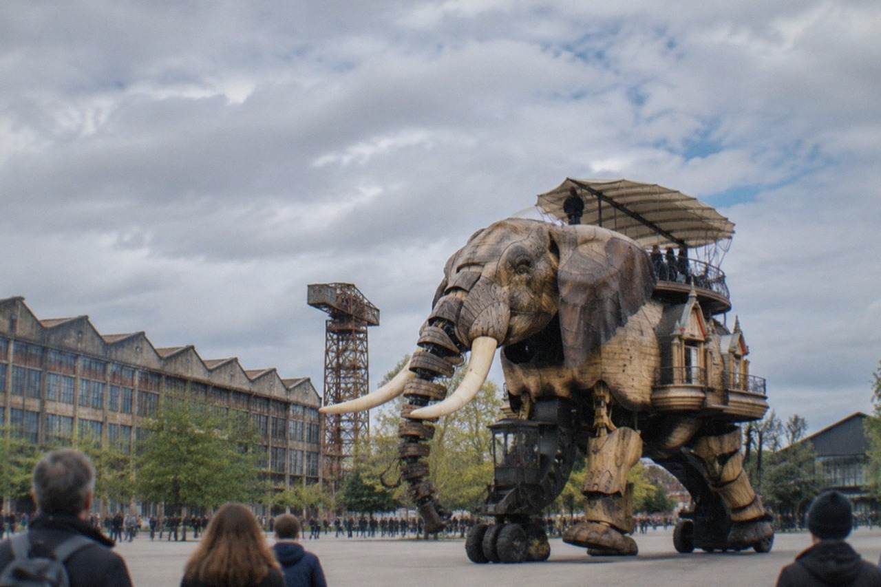The Grand Éléphant mechanical elephant walking past the former shipyard workshops on the Île de Nantes