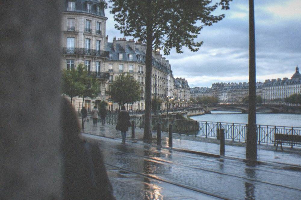 Rain-washed cobblestone street with reflections in old Nantes on an overcast afternoon