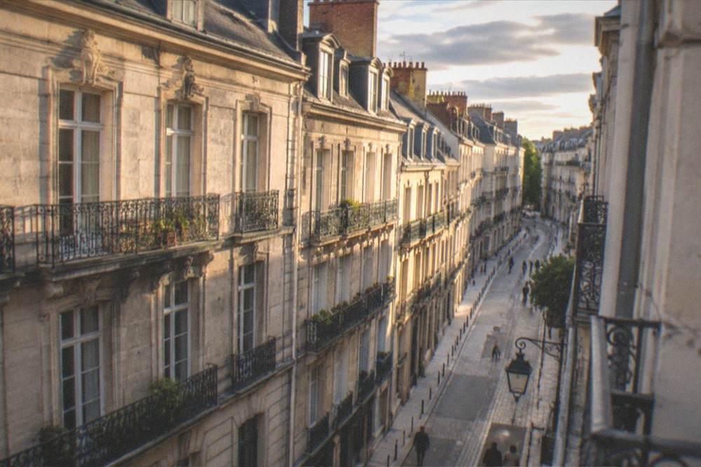 Evening light on the stone facades and narrow street of the Ile Feydeau in central Nantes