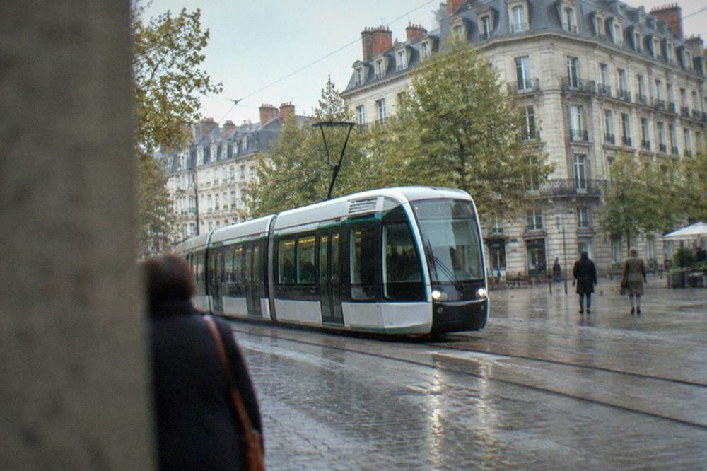 A modern Nantes tram passing through a pedestrianised street in the city centre