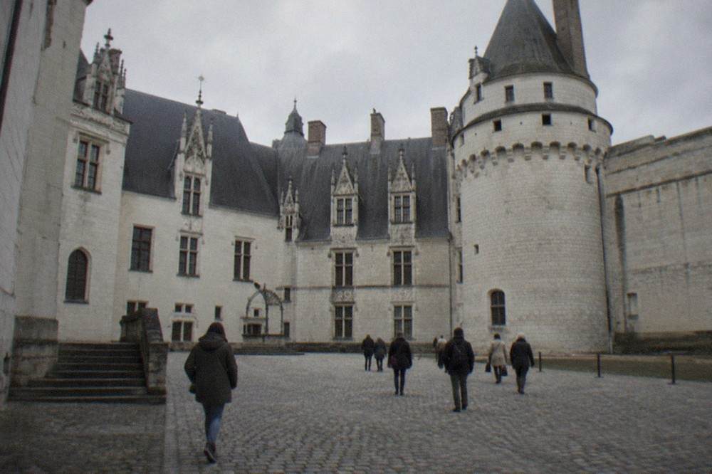 The interior courtyard of the Château des ducs de Bretagne, showing the ornate Renaissance facade with its carved stonework and large windows under a blue sky.