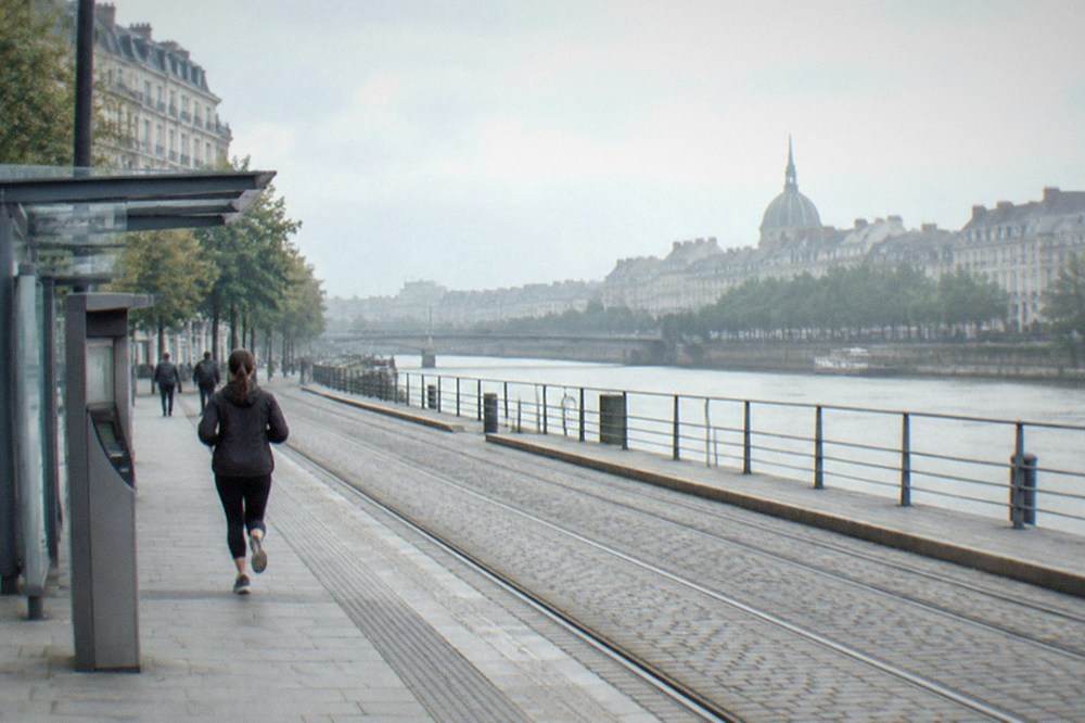 Ticket machine and tram stop shelter near a riverside quay in Nantes