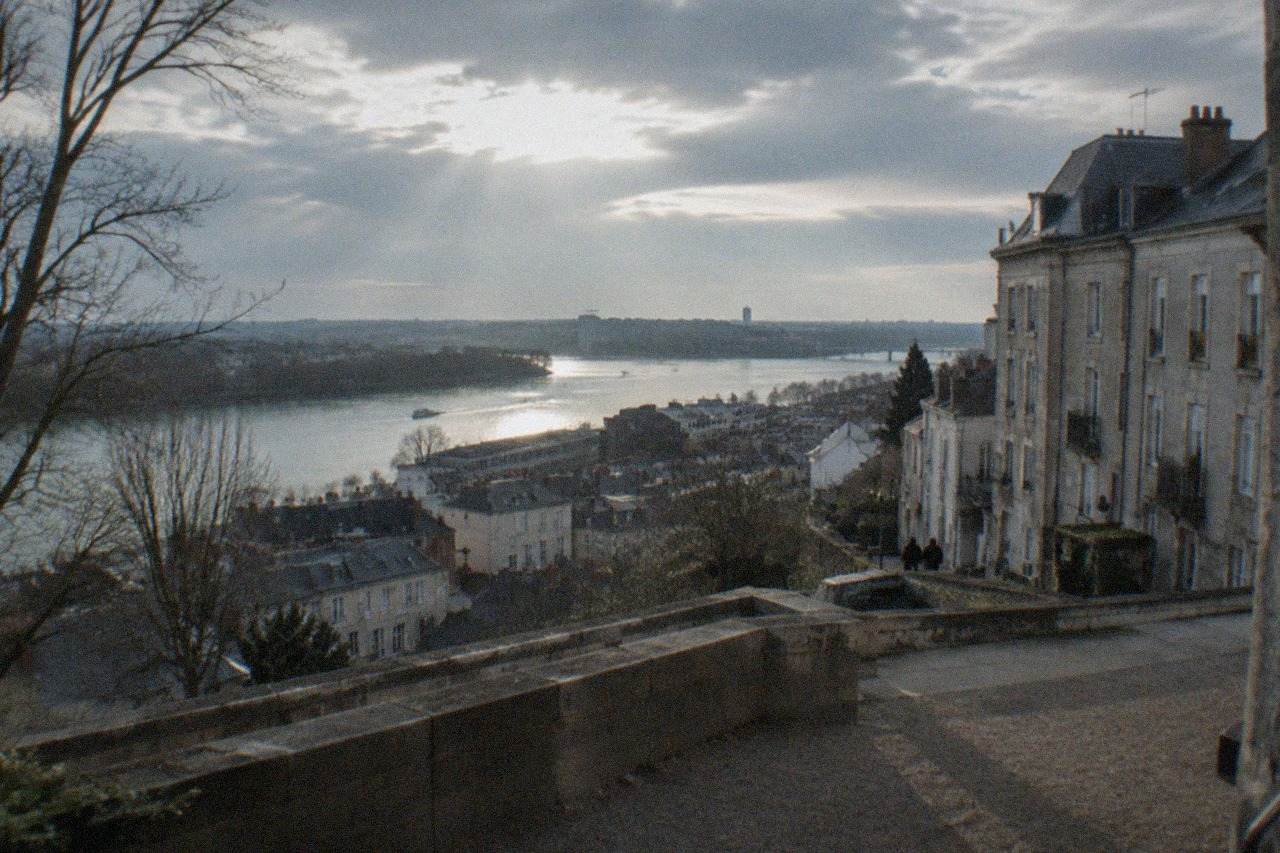 Facades of tall stone houses on a slope above the Loire in the Butte Sainte-Anne quarter of Nantes