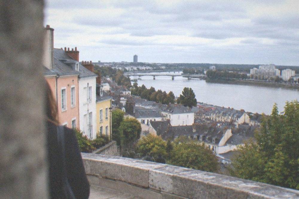 Pastel-coloured cottage facades on a stepped lane climbing the Butte Sainte-Anne hill in Nantes