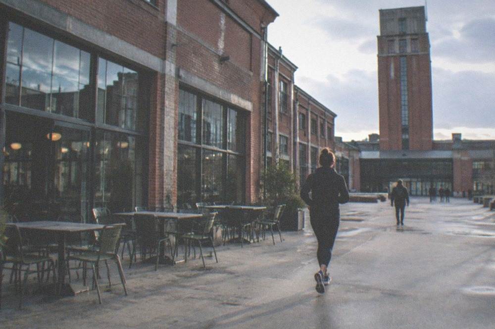 Cafe tables and chairs set out inside a converted industrial building