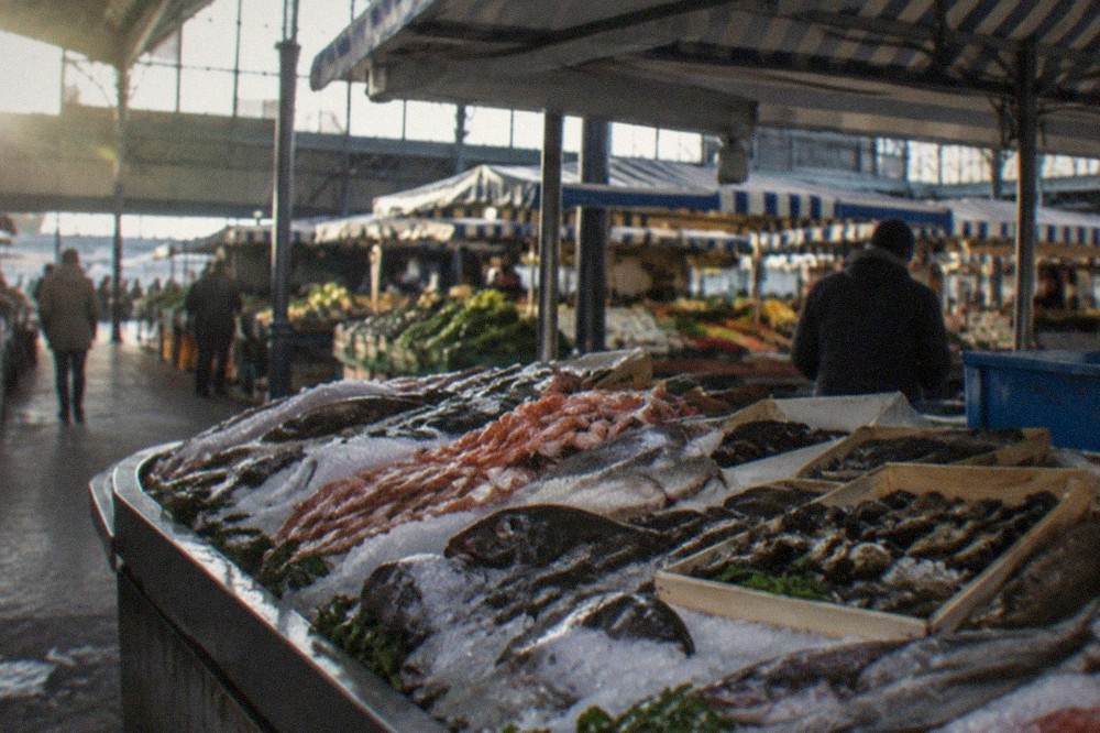 A fishmonger's stall laid out with fresh seafood on ice at Talensac market