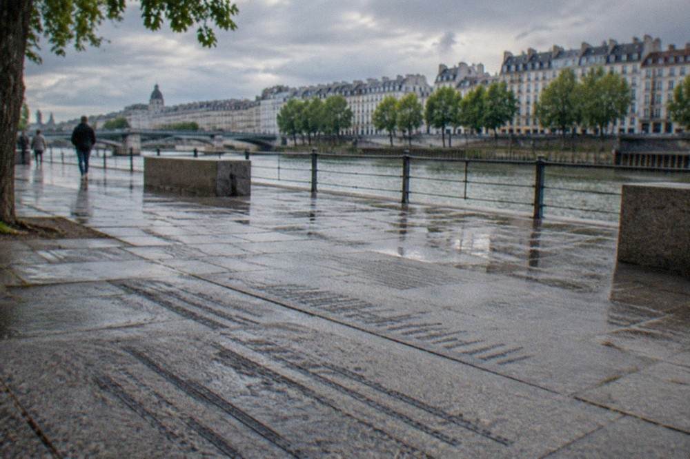 Close view of names and text cut into the stone paving of the memorial esplanade in Nantes