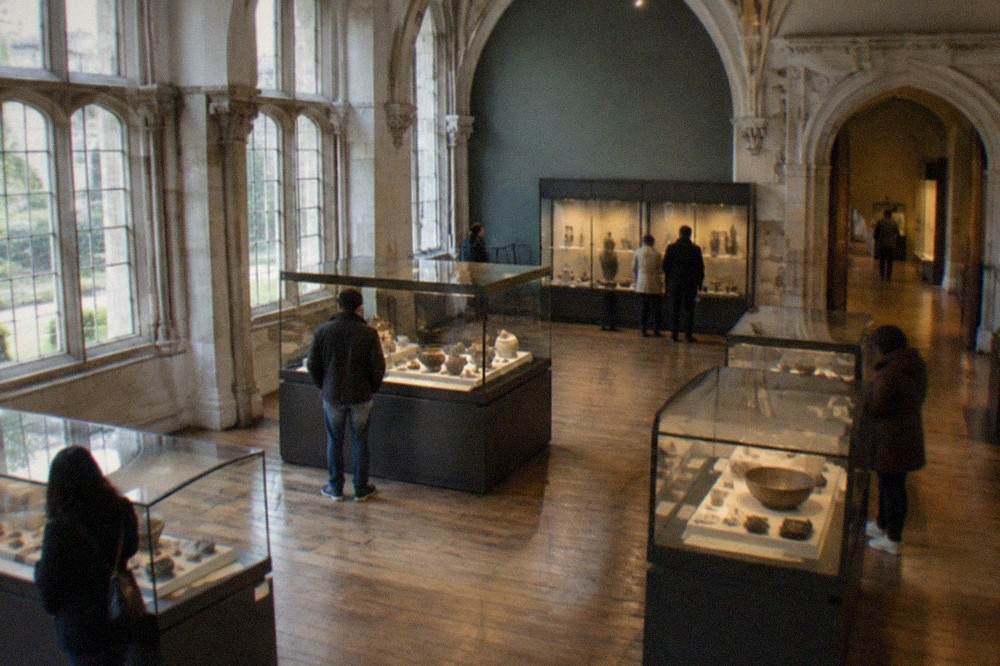 Visitors browsing display cases of historical objects inside the renovated galleries of the Musee Dobrée in Nantes