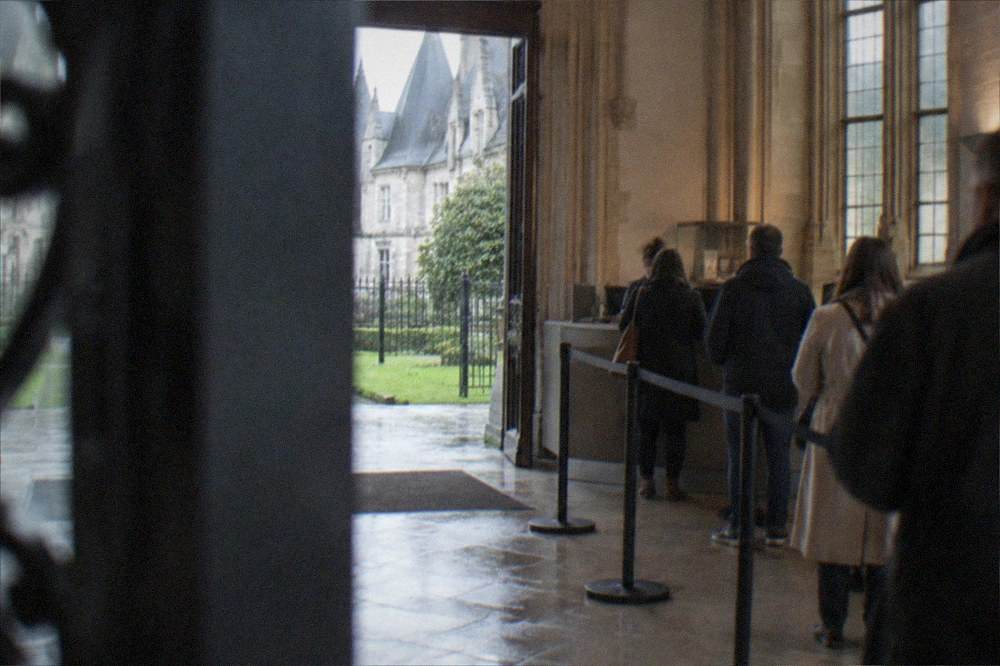 A ticket desk with a queue of a few visitors at the entrance hall of the Musee Dobrée