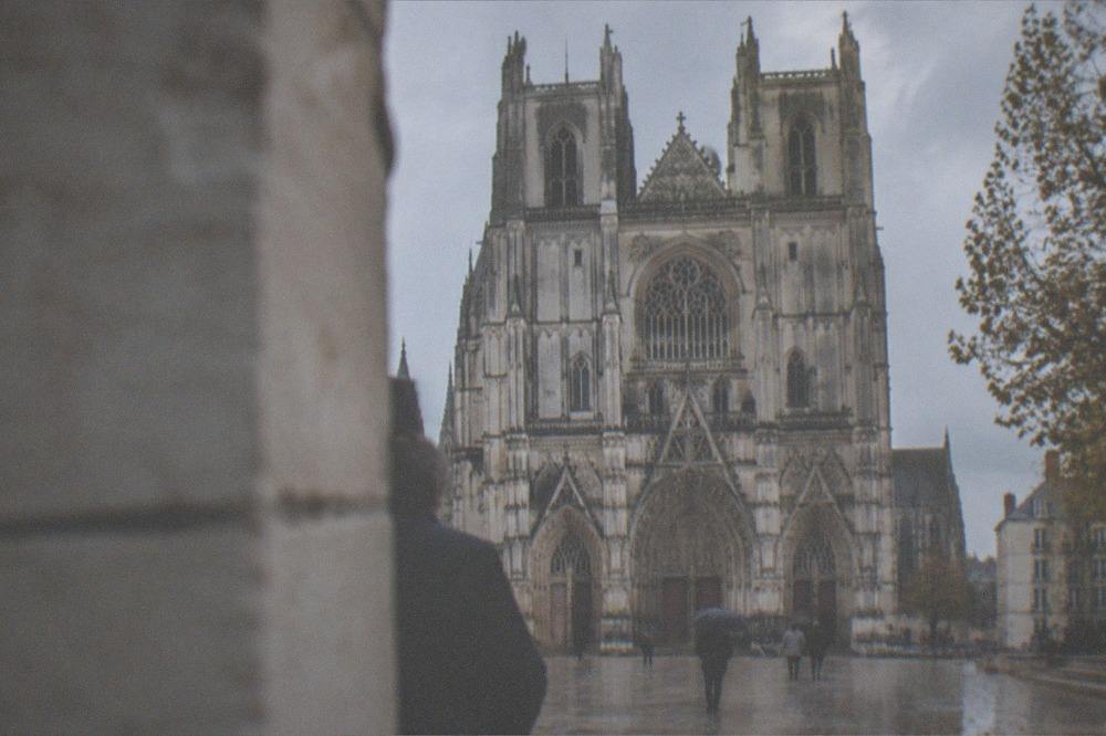 Autumn light falling on pale stone buttresses of a gothic cathedral exterior