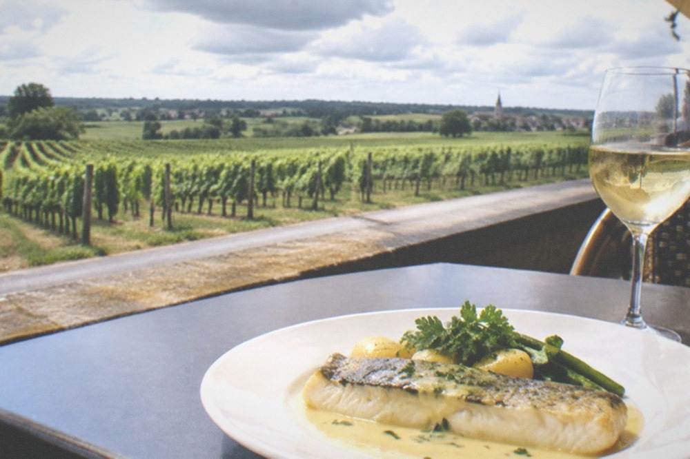 A plate of river fish with beurre blanc sauce and a glass of Muscadet in a Nantes bistro