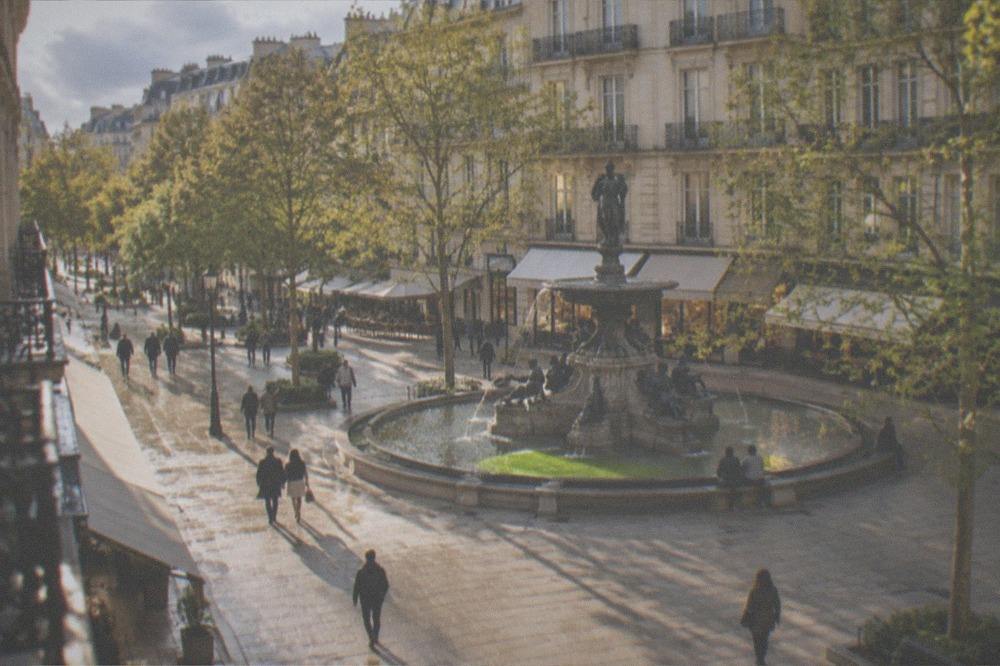 The fountain on Place Graslin in spring sunshine with plane trees leafing out