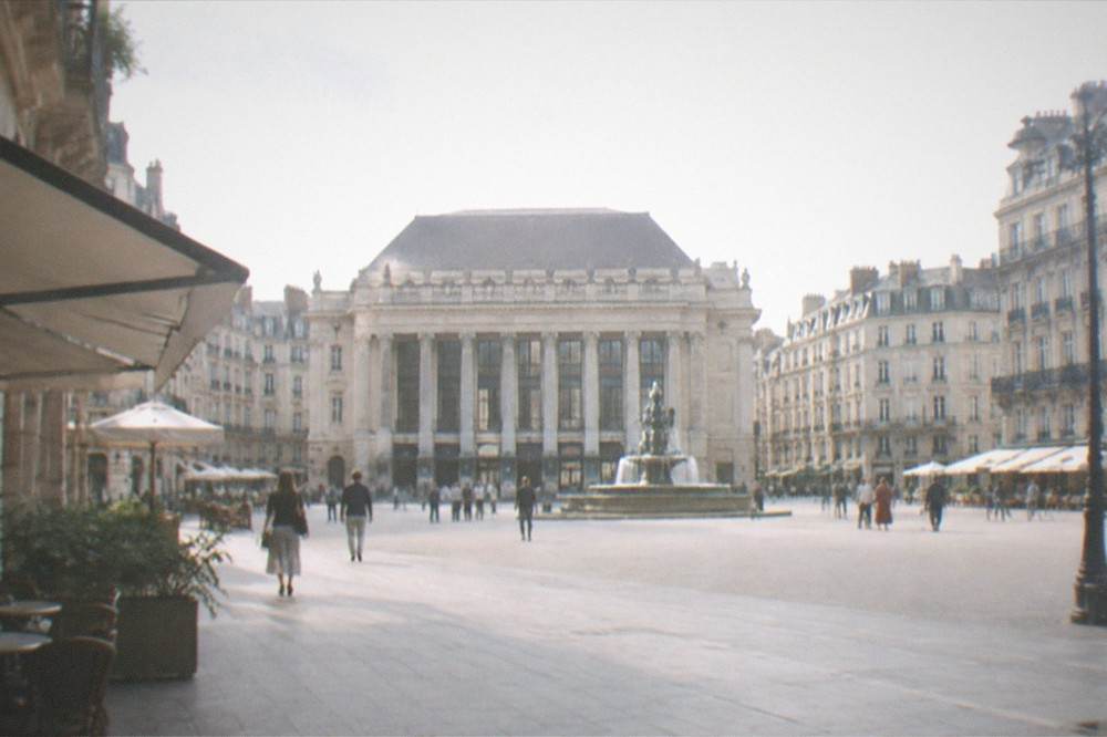 A wide view of Place Graslin in Nantes with the opera house, fountain and surrounding facades