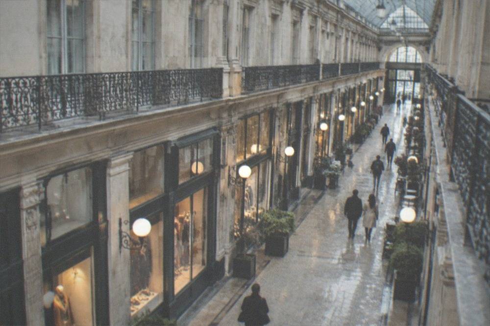 A covered 19th century shopping arcade with glass roof and elegant shopfronts in Nantes