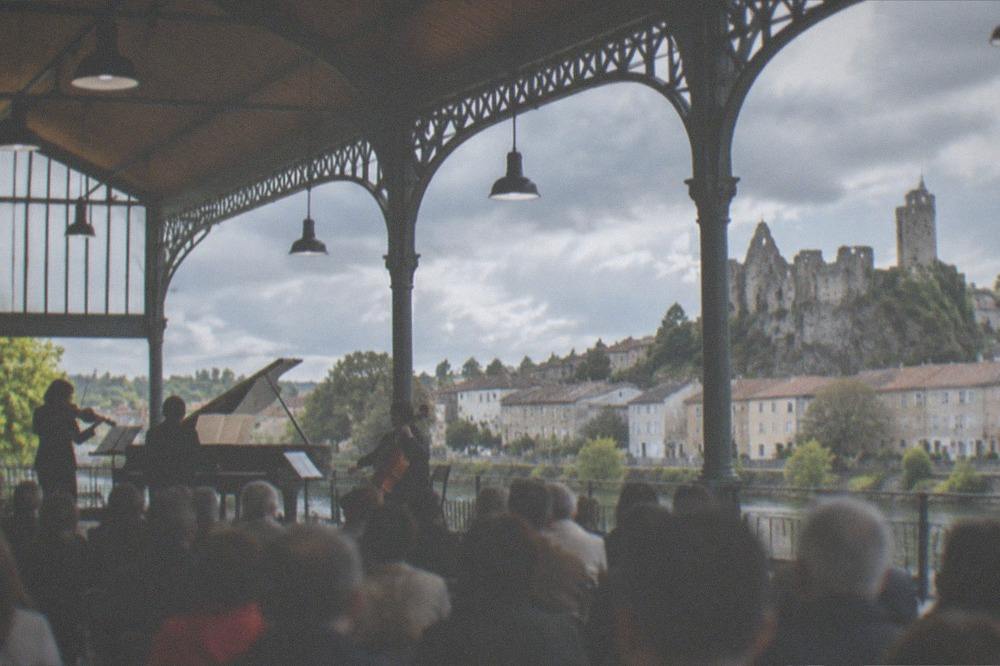 A classical music performance in progress inside a French covered market hall