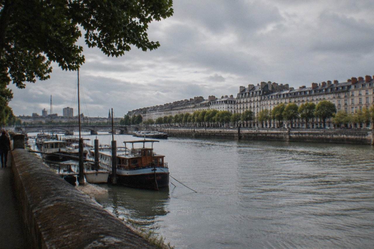 A view over the Loire river from a Nantes quayside with boats moored along the bank