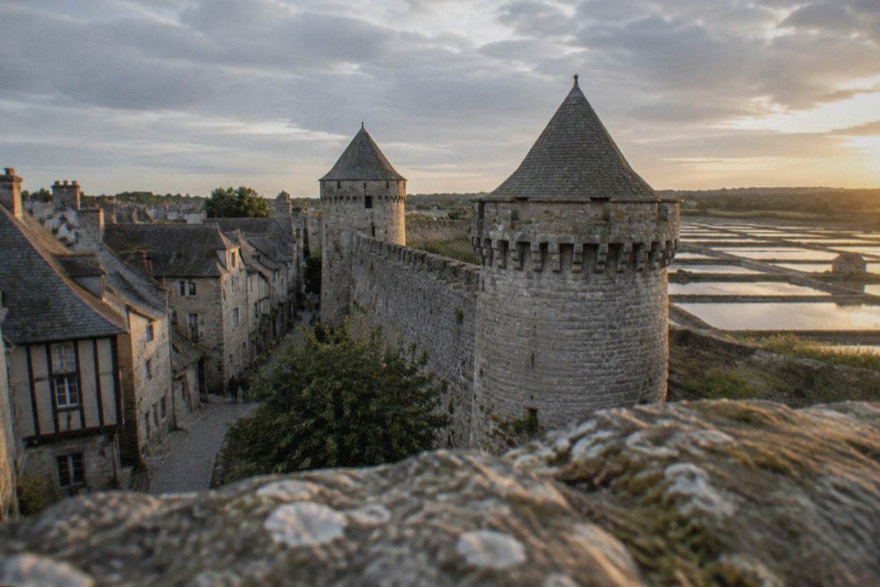 Medieval stone walls of Guerande under a bright sky with narrow streets inside