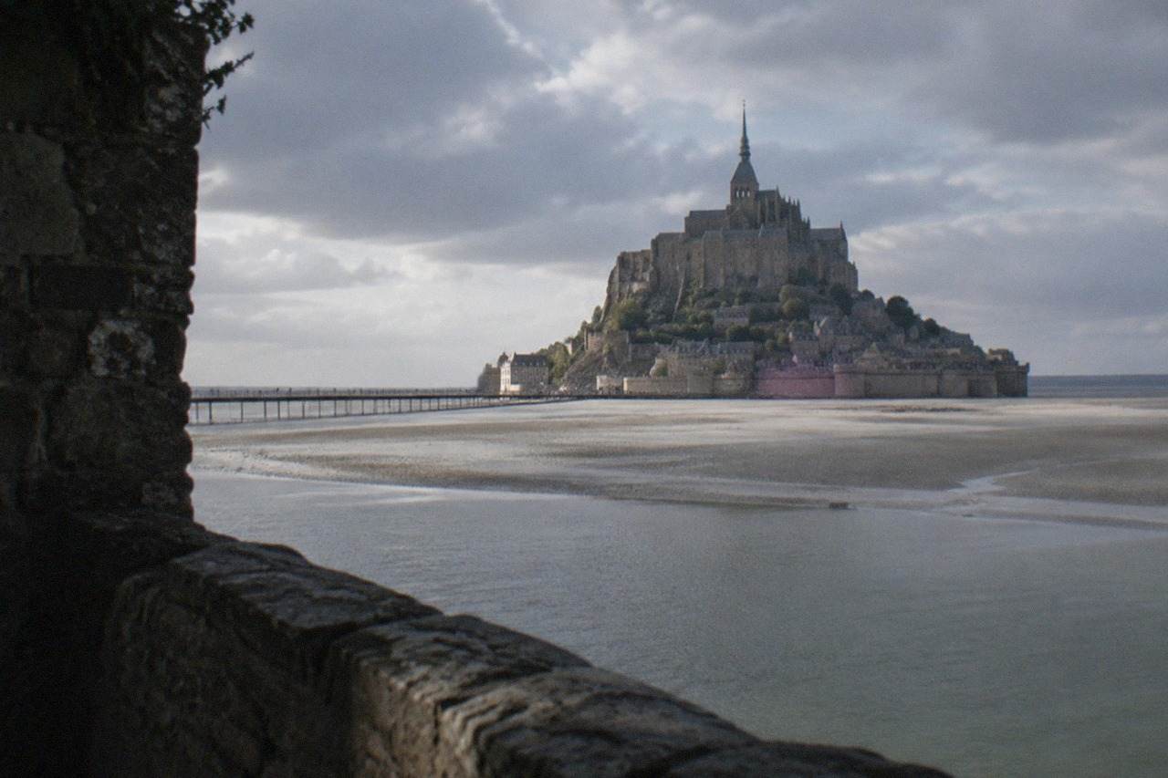 The abbey of Mont Saint Michel rising above the tidal flats of the bay