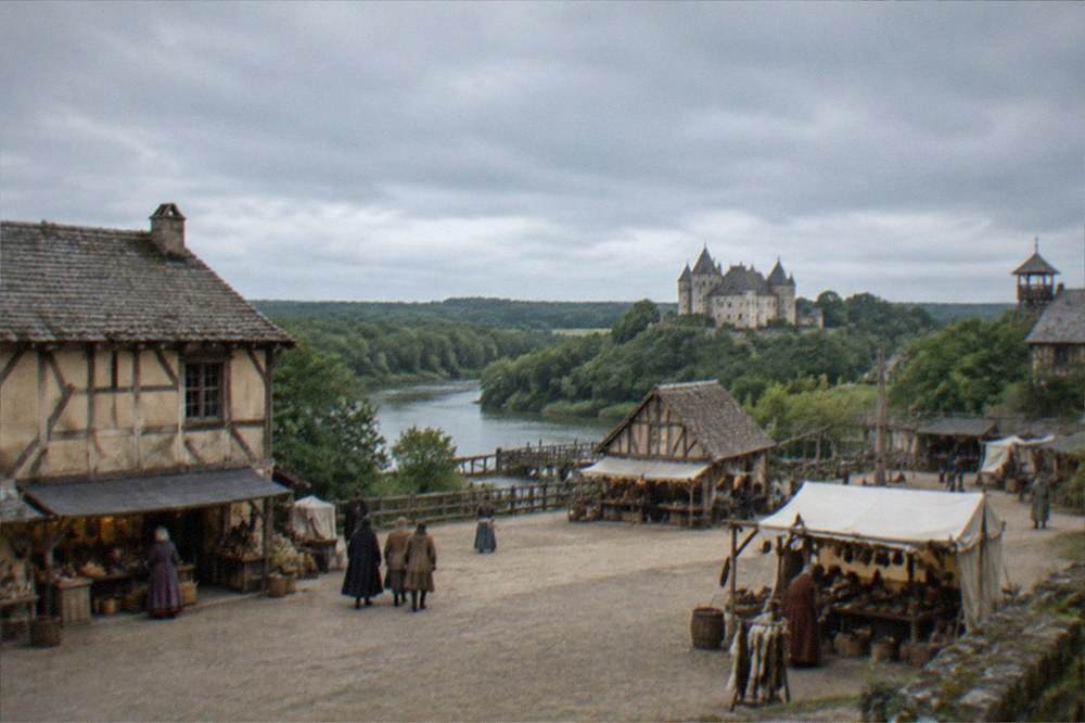 A medieval market square set with timber-framed buildings and costumed artisans