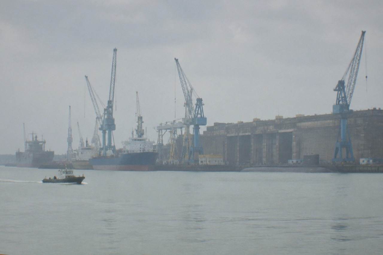 The wide Loire estuary waterfront at Saint Nazaire with ships and cranes along the quay
