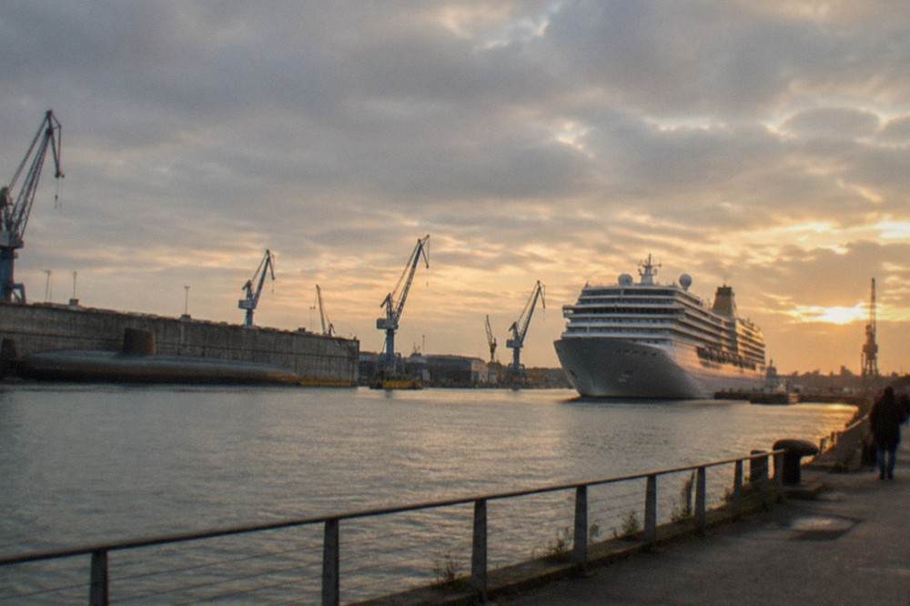 A docked passenger ship at a Saint Nazaire fitting quay seen from the waterfront walk