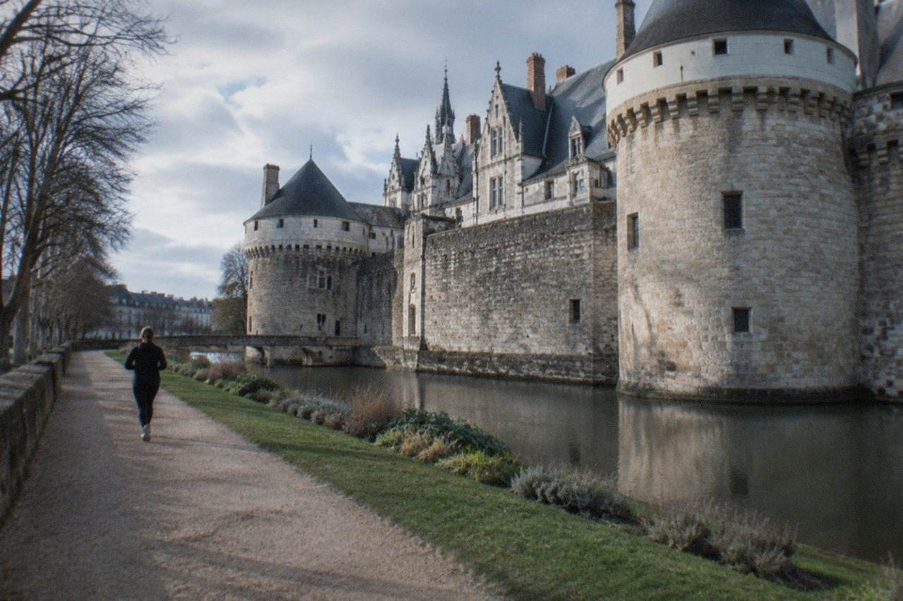 The Château des ducs de Bretagne in Nantes seen from its moat garden on a bright day