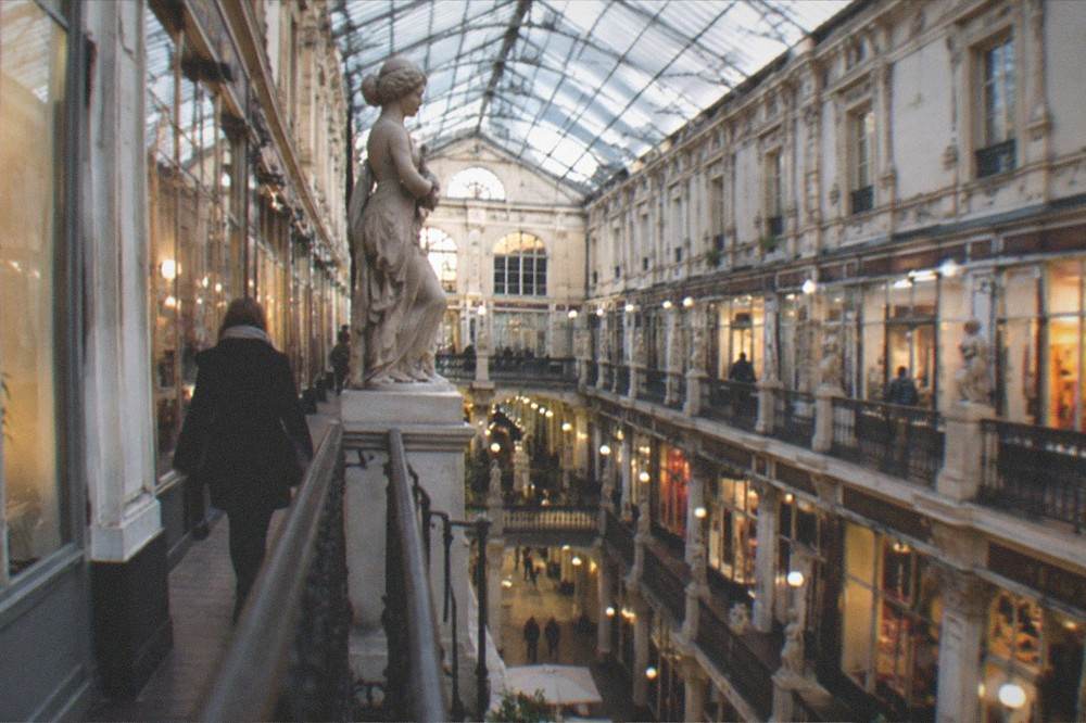 The Passage Pommeraye's glass roof and shopfronts seen from inside the shopping arcade