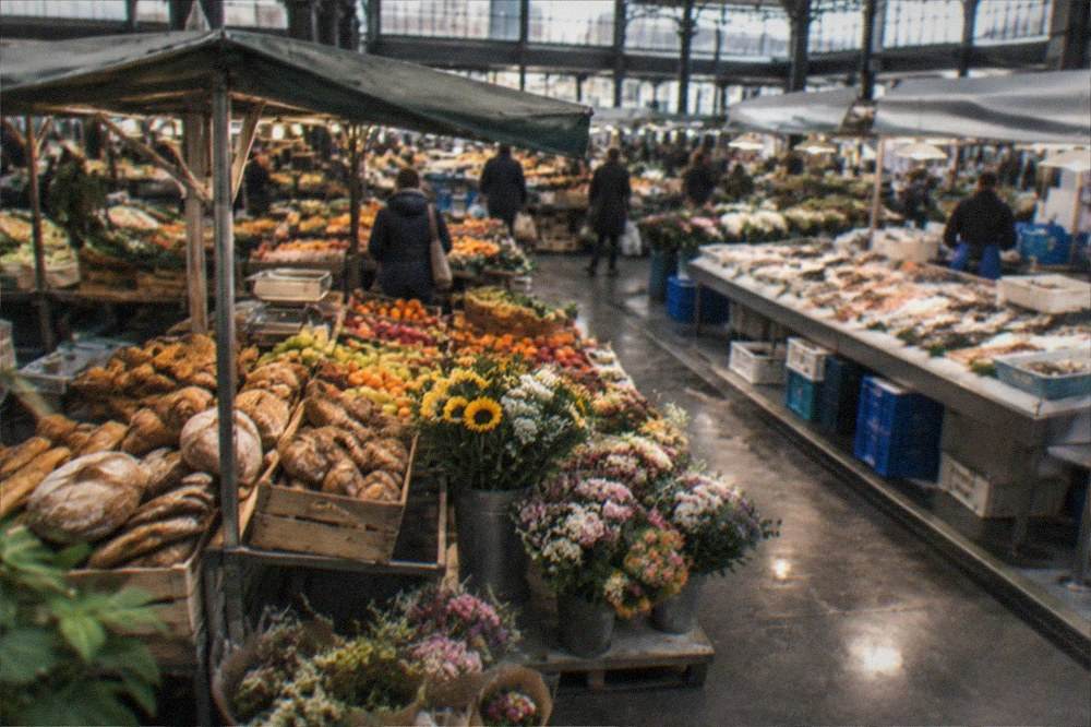 A market stall with bread, fruit and flowers in the morning