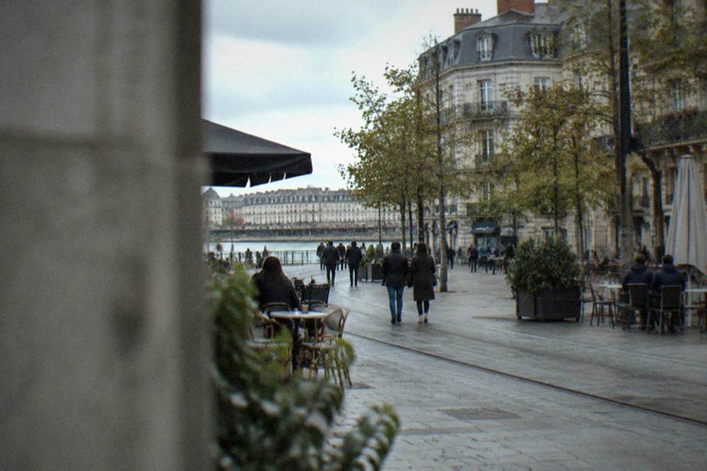 A pedestrian street in central Nantes with cafe tables and no cars in sight