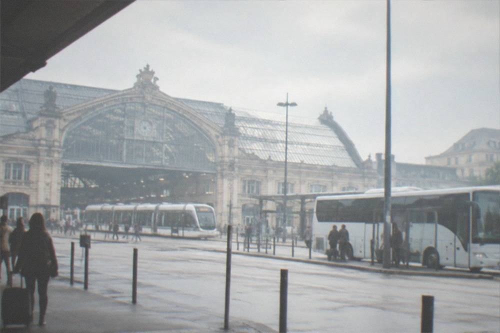 The airport shuttle bus parked at its stop near Nantes railway station
