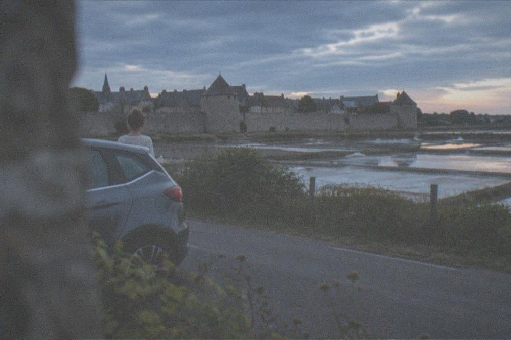 A hire car on a quiet road beside the Guérande salt marshes in late summer