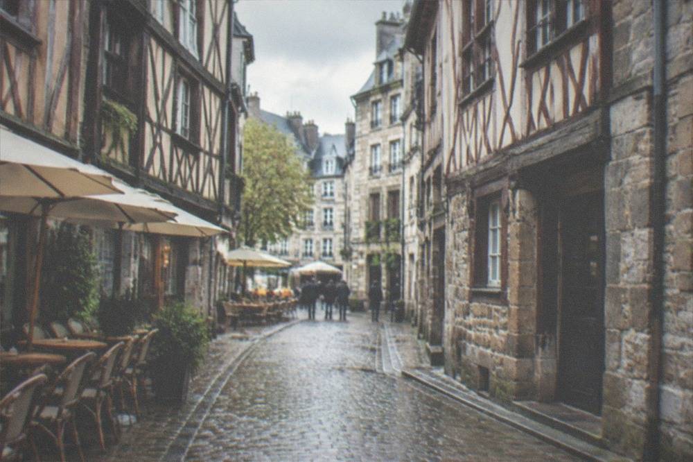 A narrow cobbled street lined with timber-framed buildings in the old town of a French city
