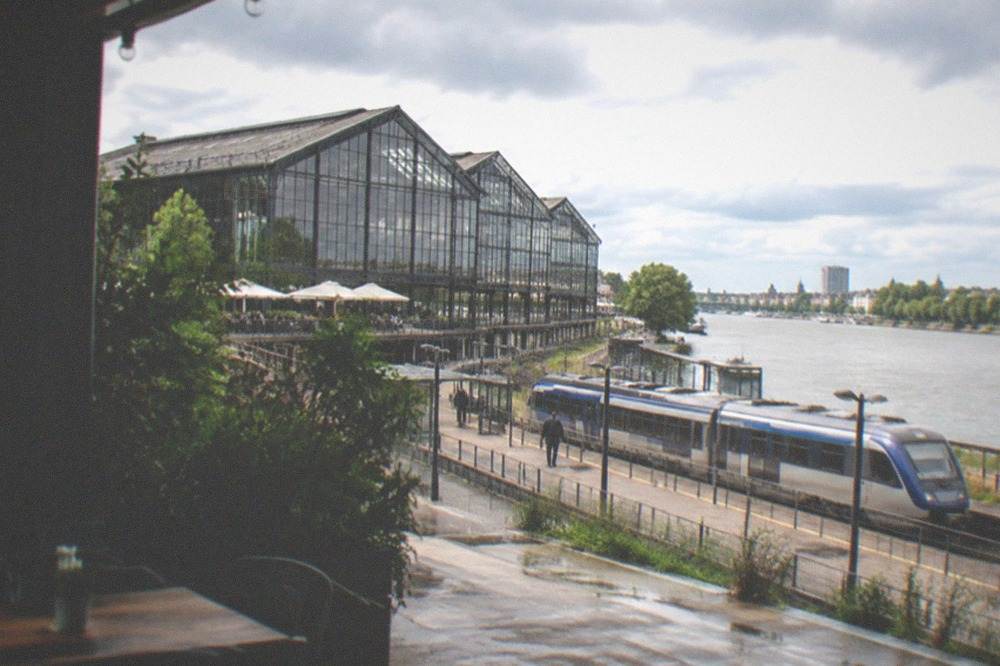 A regional train waiting at a small station platform beside the Loire