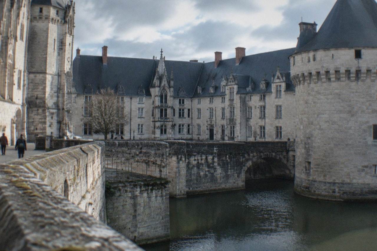 The ramparts and courtyard of the Château des ducs de Bretagne in Nantes under a bright sky