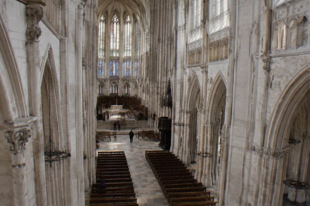 The white Gothic interior of Nantes Cathedral seen from the nave towards the choir
