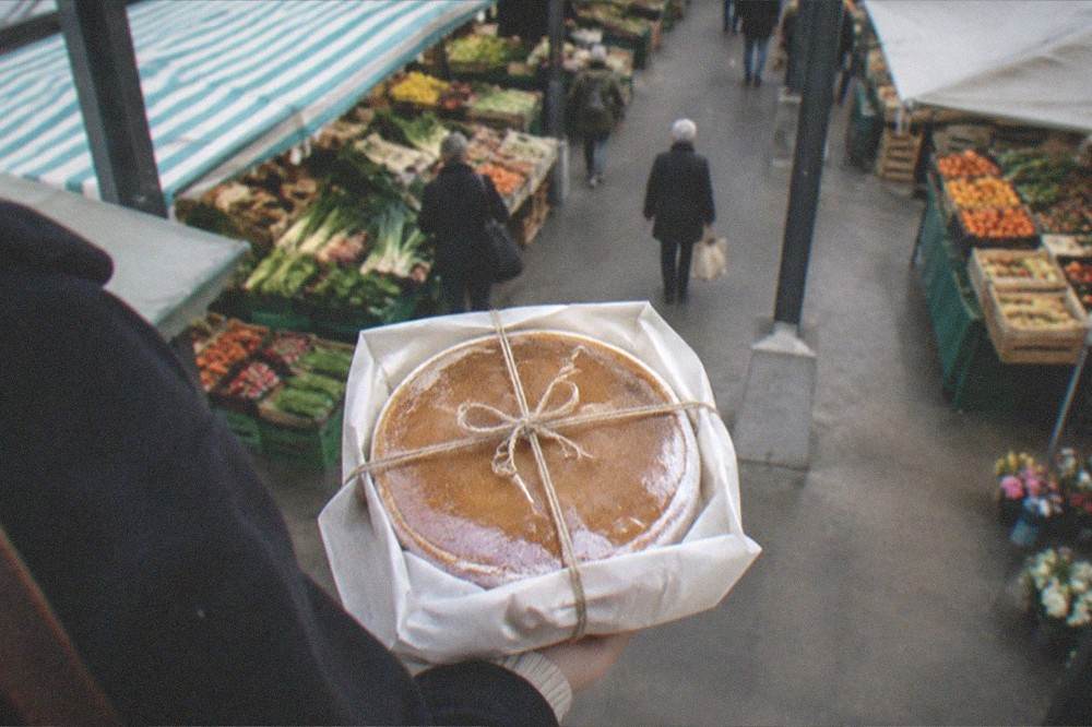 A whole gâteau nantais boxed in paper and tied with string, ready to carry as a gift
