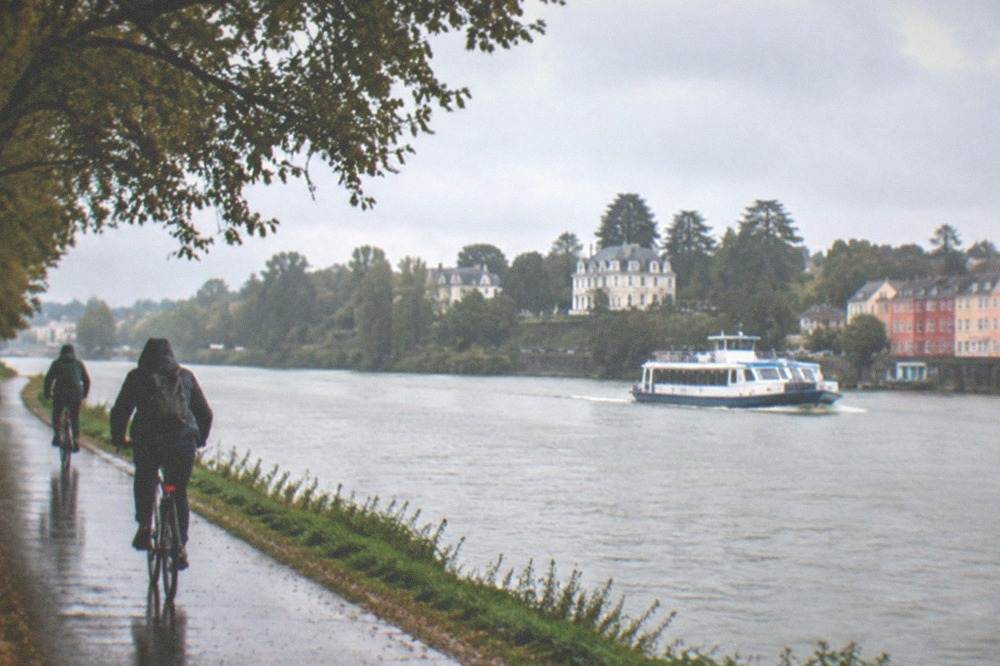 A small passenger ferry crossing the Loire towards the colourful houses of Trentemoult