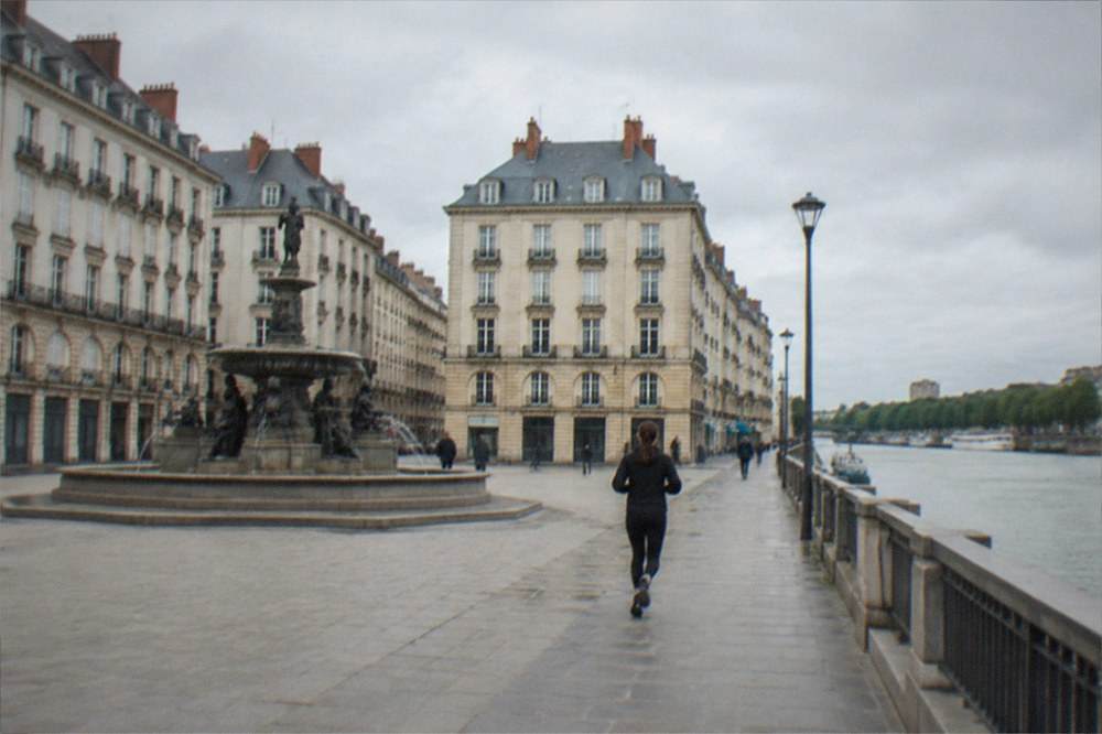A riverside walkway along the Loire with boats moored on the far bank