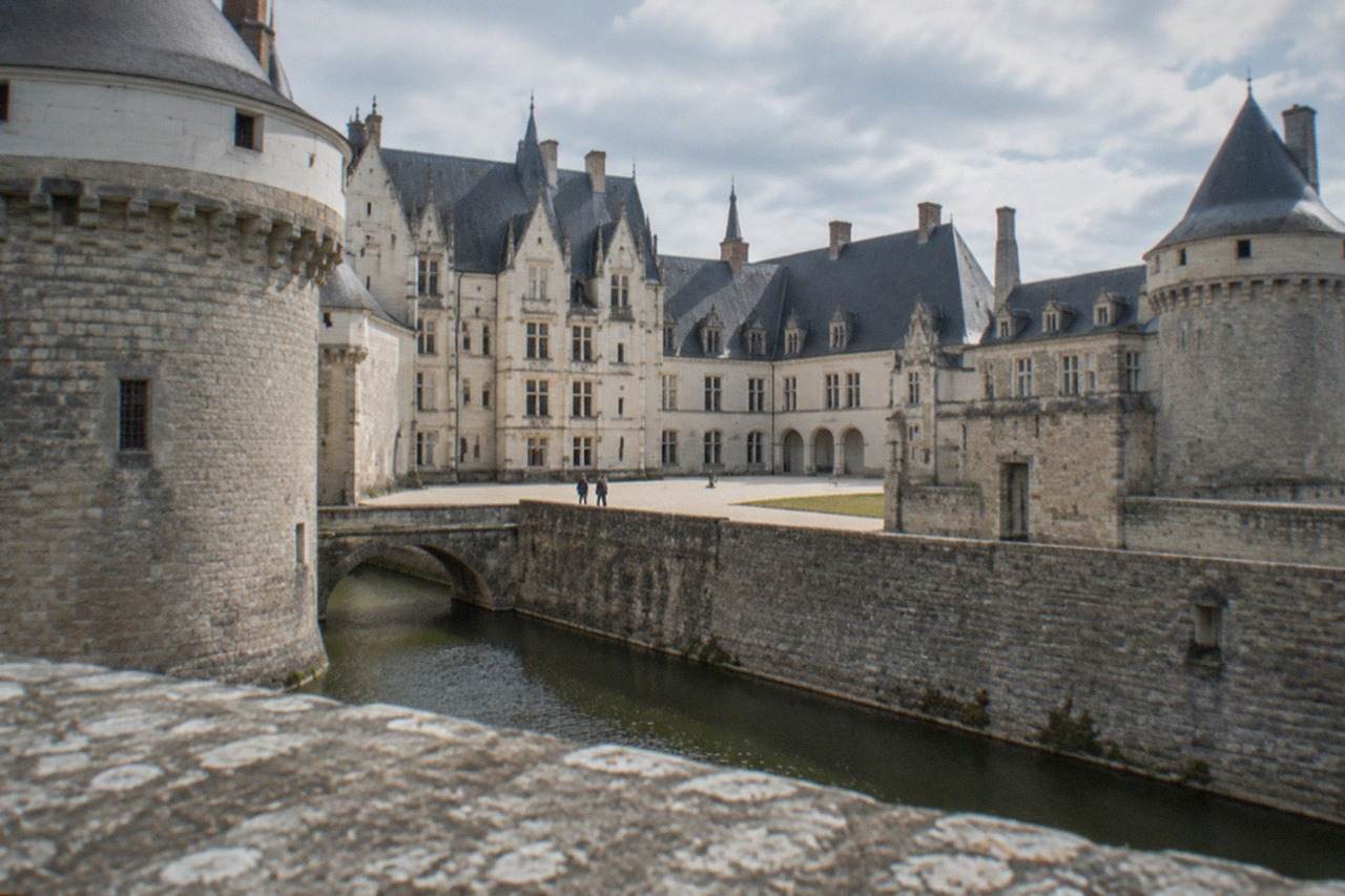 The ramparts and courtyard of the Chateau des ducs de Bretagne in Nantes under a soft sky