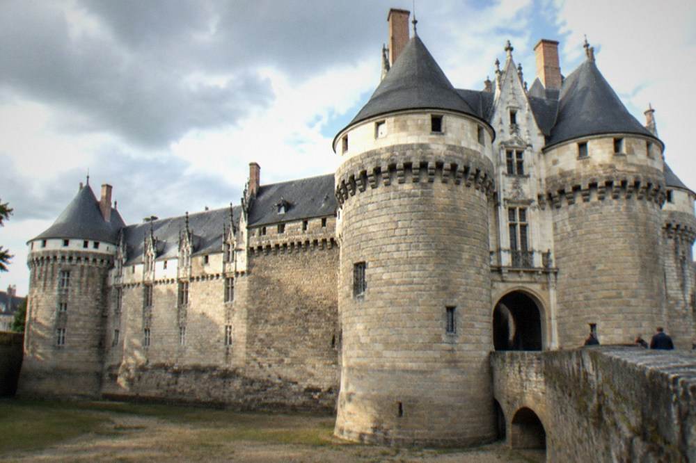 The stone gateway and towers of the Chateau des ducs de Bretagne seen from the dry moat