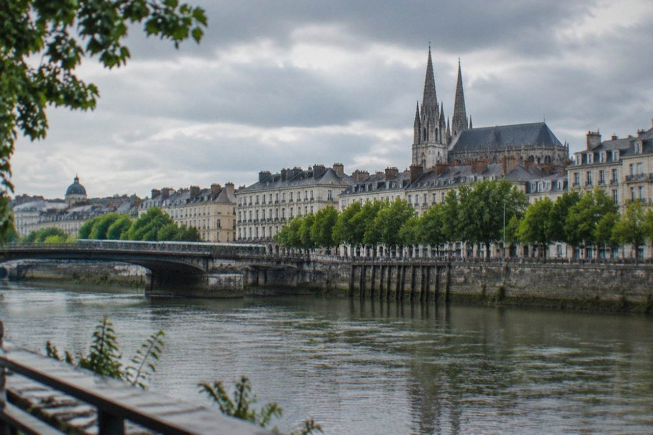 View over the Loire river in Nantes with the historic city skyline and the spires of the cathedral in the distance